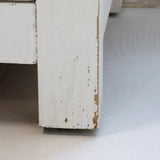 Antik krém szekrény lábazatának részlete patinás festéssel