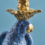 Kék színű papagájfigurás gyertyatartó.