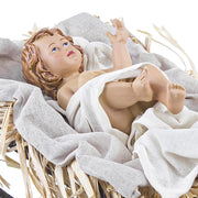 Sacred kis Jézus figura jászolban fehér textíliák és szalma között