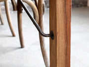 Összecsukható lábbakkal kialakított, kézműves étkezőasztal.