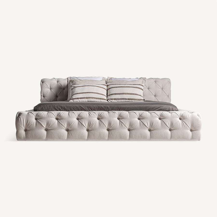 Világosbézs színű szövettel kárpitozott nagy design franciaágy.