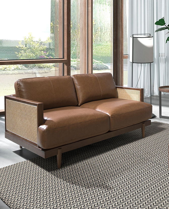Barna színű marhabőrrel kárpitozott, rattanbetétes, 2 személyes design kanapé.