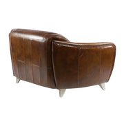 A kanapé hátsó nézete átlós szögből, ahol jól látható a természetes bőrfelület és a letisztult forma.