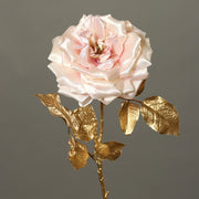 Fényes aranyszínű szárú és levelű, halvány rózsaszín színárnyalatú szatén rózsa művirág .