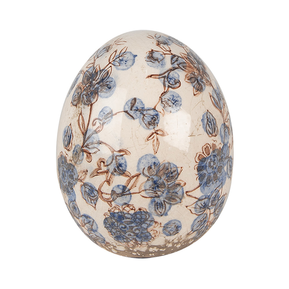 Kék színű növényi motívummal díszített kerámia tojás.