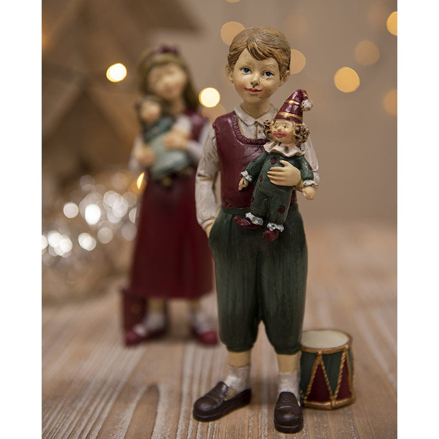 Karácsonyi kisfiú bohóccal és dobbal.