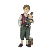 Karácsonyi kisfiú bohóccal és dobbal.