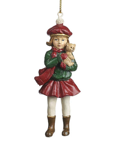 Mackót tartó, piros és zöld színárnyalatú téli kislány formájú karácsonyfadísz.