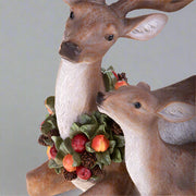 Ünnepi gyümölcskoszorúval díszített, karácsonyi szarvas család.
