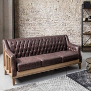 Loft stílusú, sötétbarna bőrrel kárpitozott kőrisfa kanapé.