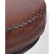 Az ipari stílusú bárszék bőr ülőfelületét díszítő X alakú varrások.