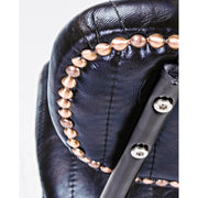 Vintage stílusú bárszék sötétkék műbőr háttámlájának aranyszeges díszítése.