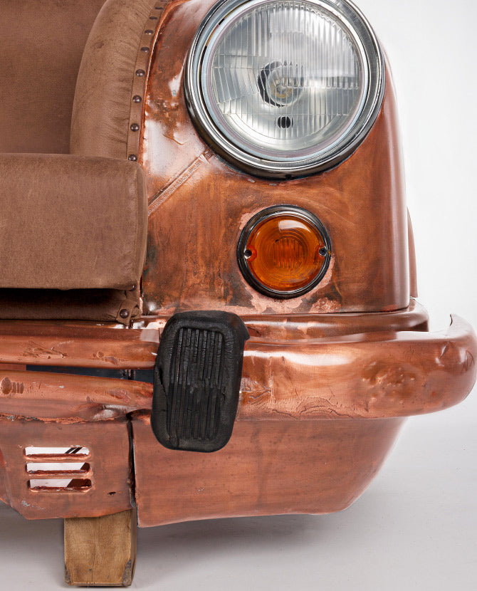 Bronz színű autófront kanapé lámpa és lökhárító részlete.