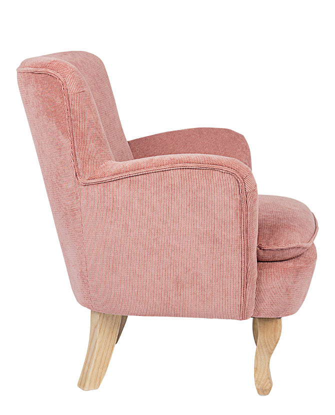 Retró stílusú, púderrózsaszín színű, kordbársony-hatású szövettel kárpitozott kaucsukfa fotel.