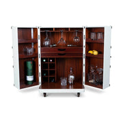 Századfordulós utazási bőröndök stílusában készült bárszekrény italokkal, poharakkal és gyümölcsökkel.