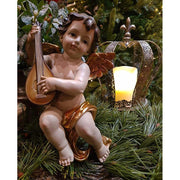 Lanton játszó, karácsonyi angyal puttó figura fenyőfa és fagyöngy között arany koronával 