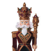 Aprólékosan kidolgozott, barokkos megjelenésű műgyanta diótörő, melyet bársony anyag és sujtás díszít