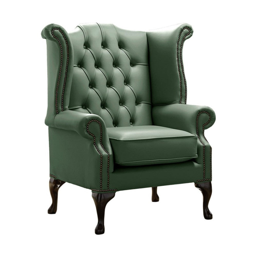 Lombzöld színű bőrrel kárpitozott Chesterfield szárnyas fotel.