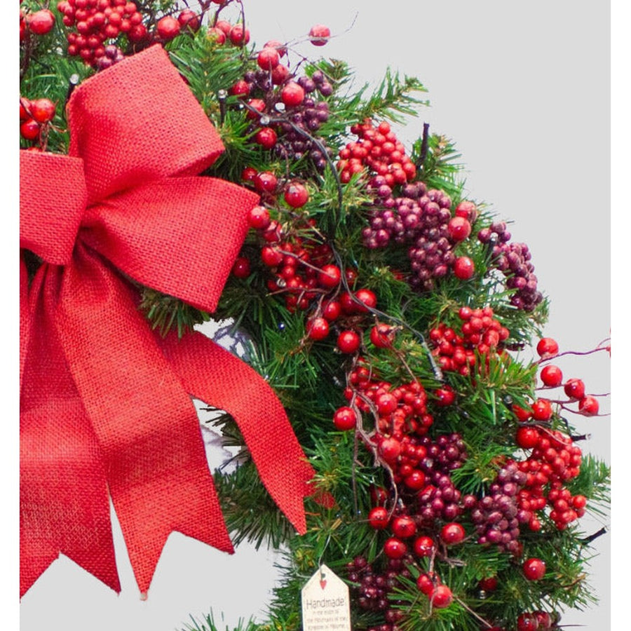 Vidéki stílusú, erdei bogyós, 102 cm átmérőjű karácsonyi koszorú masnival.