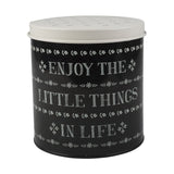 Fémből készült, fekete és fehér színű, motívumokkal és "Enjoy the little things in life" felirattal díszített konyhai tárolódoboz