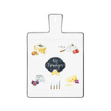 Fekete szegéjű, fehér színű porcelán vágólap zöldségmotívumokkal és kitchen felirattal