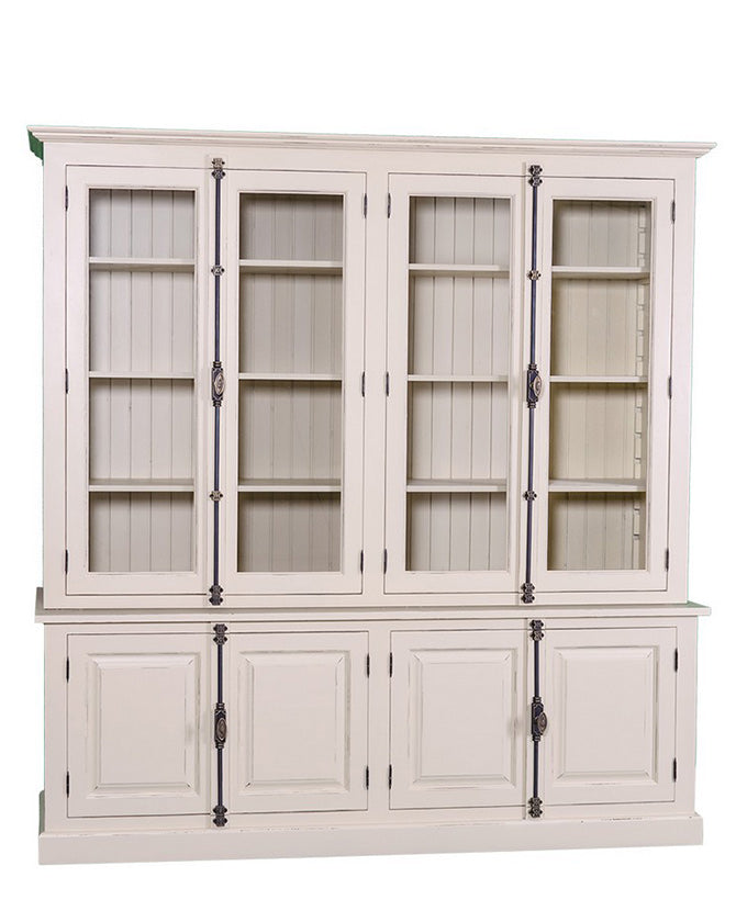 Fenyőfából készült impozáns könyvszekrény két darab, kétszárnyú üveges ajtóval a felső részén, és két darab, zárt kétszárnyú ajtós tárolóval az alsó részén.  A bútor színe krémszín.
