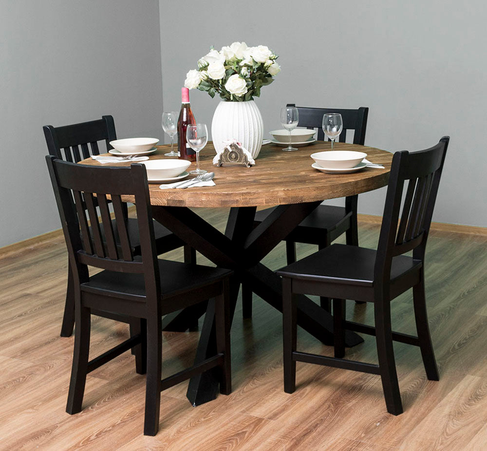 Étkezőben álló kerek formájú étkezőasztal négy darab, fekete színű fenyőfa székkel.