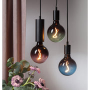 A Colourmix termékcsalád három izzója (zöld, mályva és kék) dekorfoglalatban.