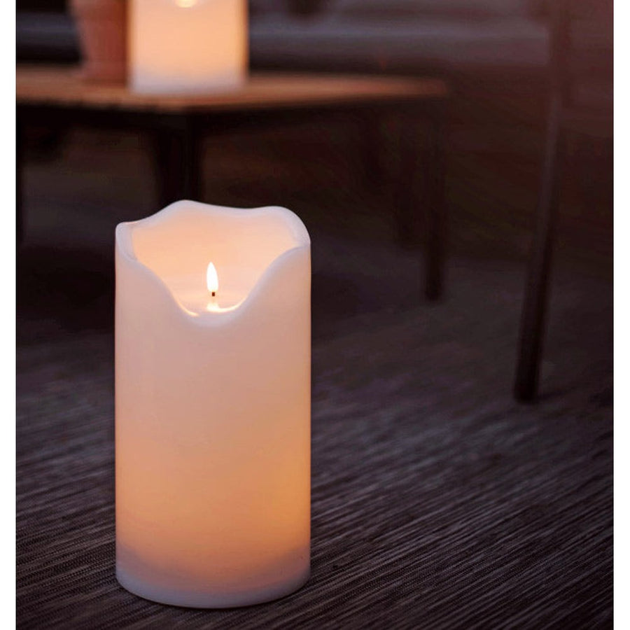 Kültéri teraszon álló, két különböző méretű fehér színű LED gyertya.