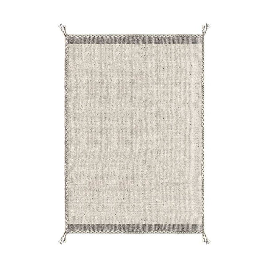 Bézs színű gyapjú szőnyeg.