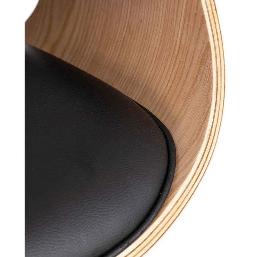 Prémium kategóriás, modern illetve loft stílusú, állítható magasságú, dió furnéros, fekete műbőr kárpitú, kerekes irodai vezetői forgószék