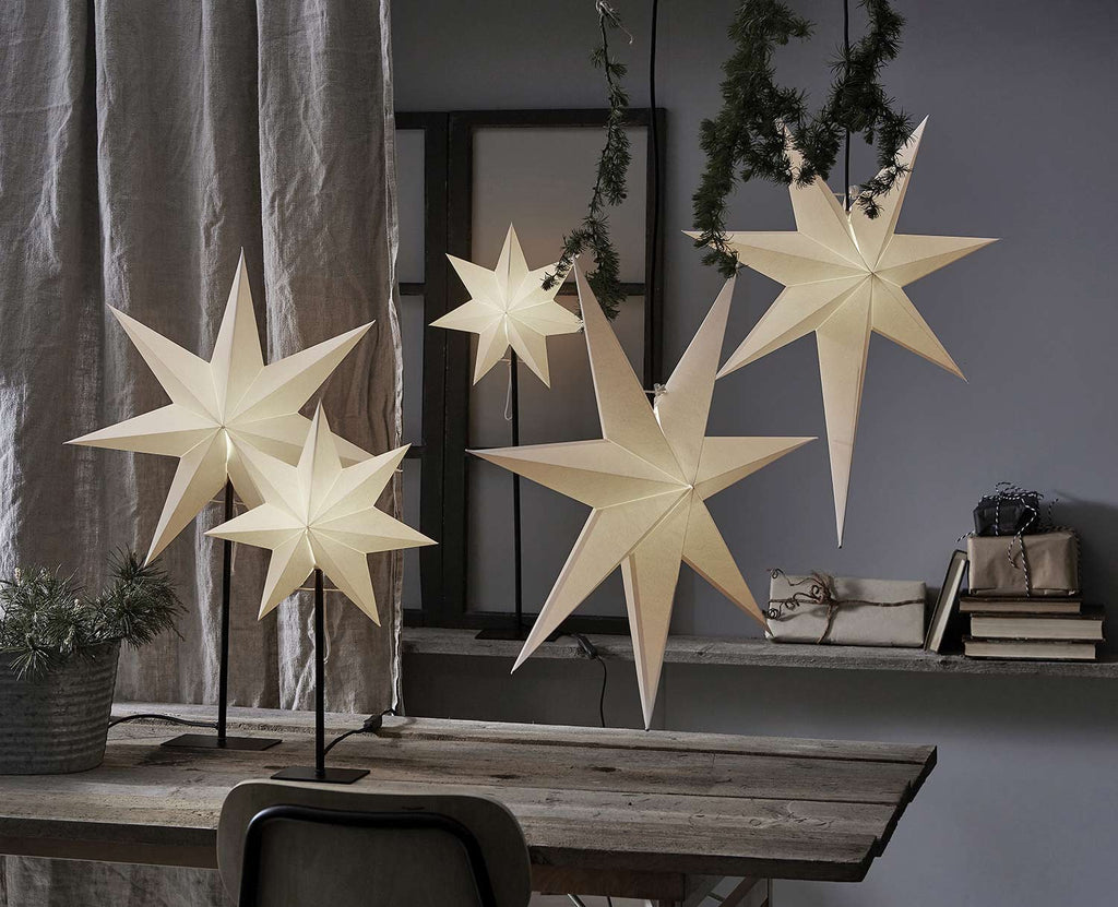 Többféle méretű és formájú, fehérszínű, világító karácsonyi papírcsillagok,.