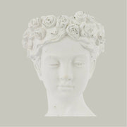 Antikolt felületű, krém színű kaspó büszt.