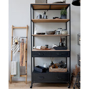 Loft, ipari stílusú, kerekekkel felszerelt, antik fekete színű, fém fiókos polcos állvány  konyhában, konyhai eszközökkel a polcain