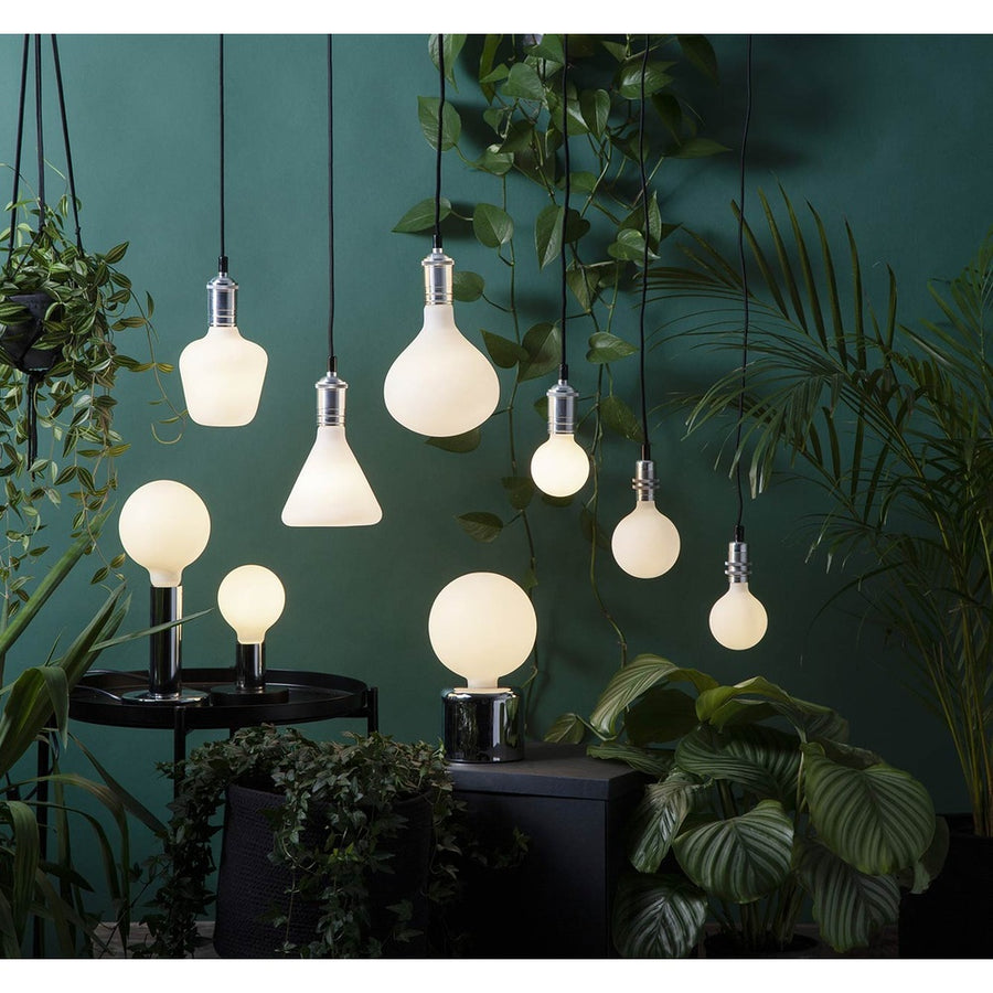 Matt felületű opál LED izzók zöld növények között.