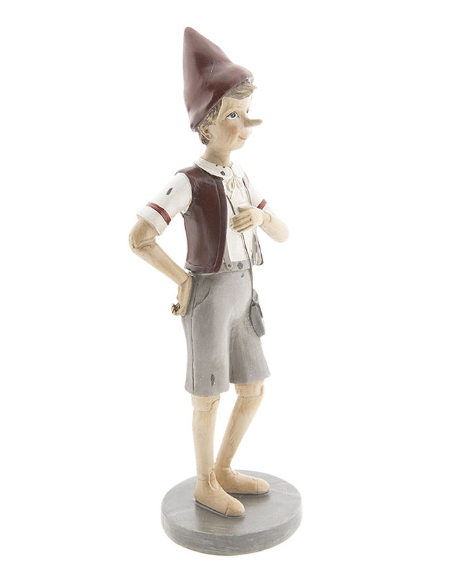 Vintage stílusú, tarisznyát viselő Pinokkió-figura.